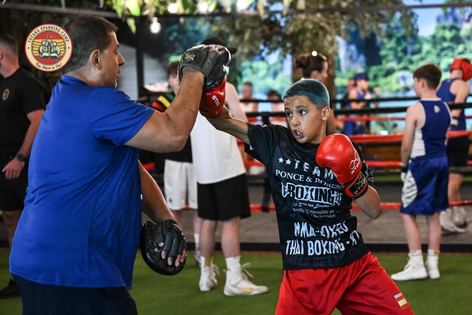 Schools boxer on the pads with their coach